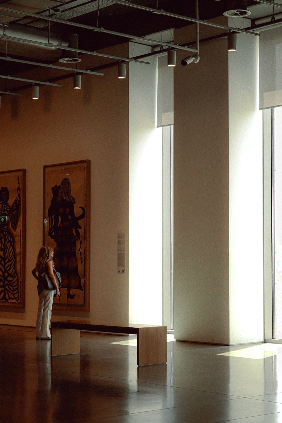 Sunlit corner of a modern art gallery with sculptures