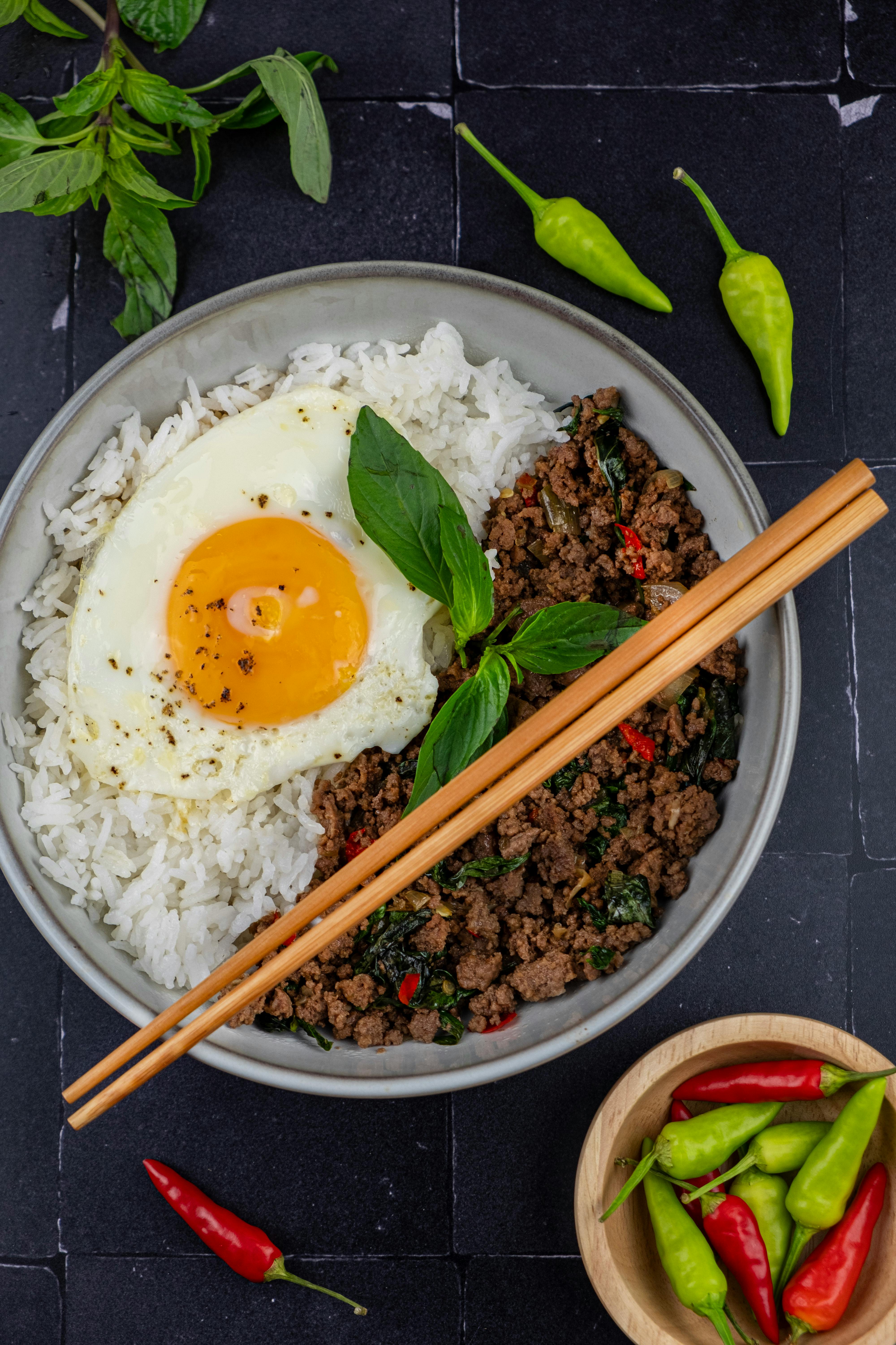 Free Delicious Thai basil beef served with a perfectly fried egg over fluffy rice. Stock Photo