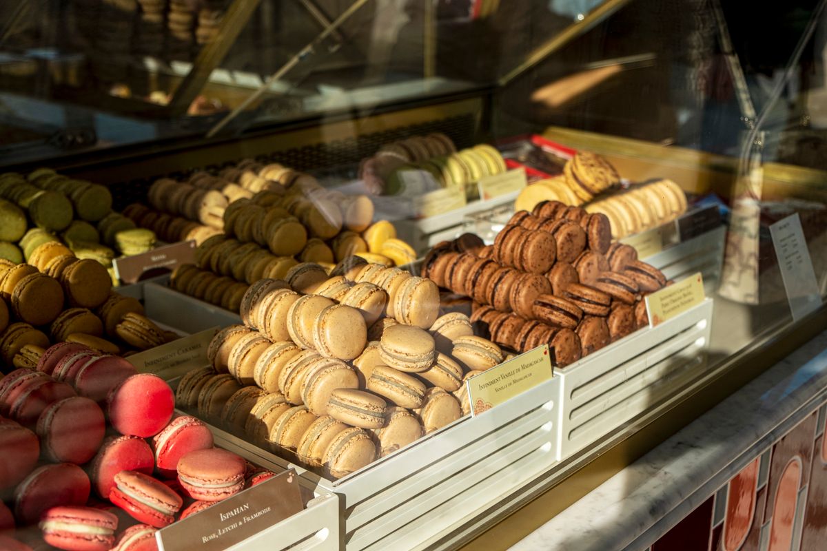 Macarons in a Parisian patisserie window at golden hour