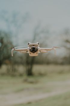 Compact drone flying outdoors on a clear day, showcasing modern aerial technology.