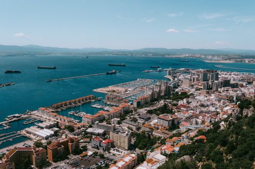 Free A stunning aerial view of Gibraltar city and its harbor, showcasing the vibrant coastal landscape. Stock Photo
