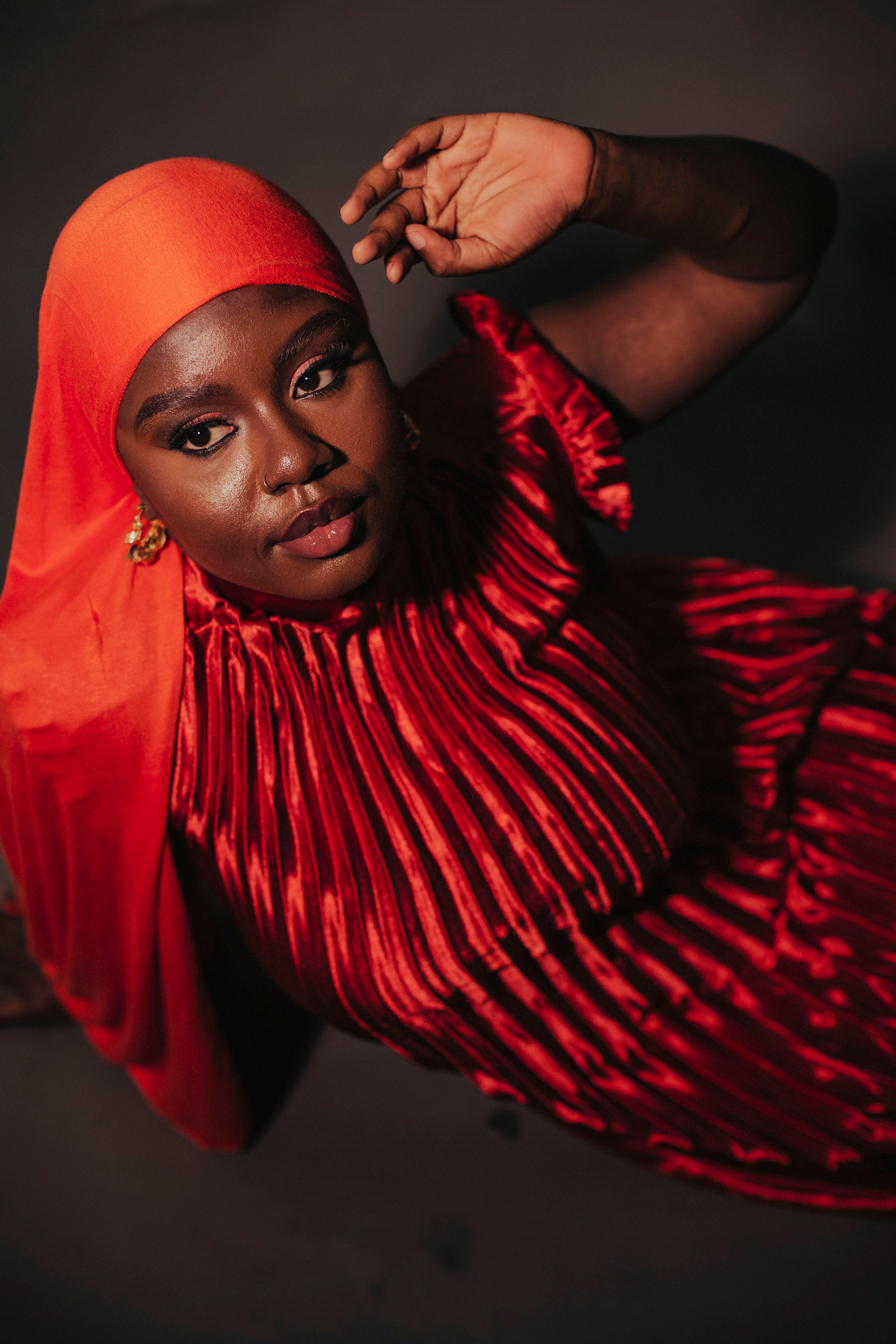 Elegant Portrait of a Woman in Red and Orange Hijab · Free Stock Photo