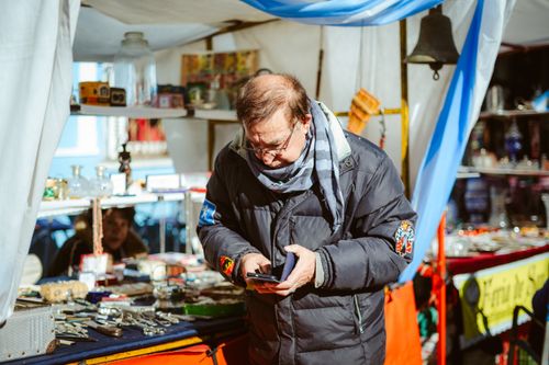 Free Man browsing items at a vibrant flea market in Buenos Aires, Argentina. Stock Photo