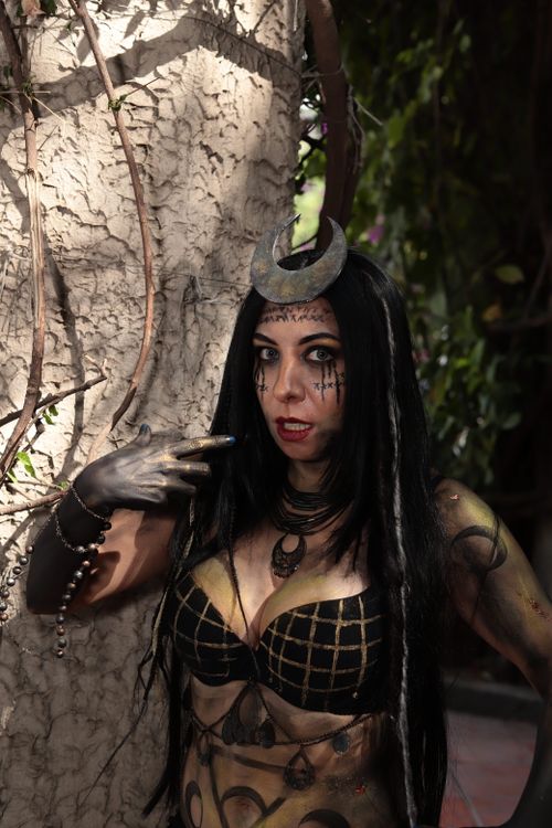 Free Woman in fantasy cosplay with dark makeup and unique headpiece outdoors. Stock Photo