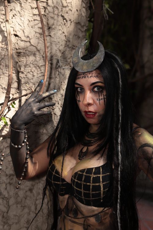 Free Fantasy character with crescent crown and dark makeup conveying mystery. Stock Photo