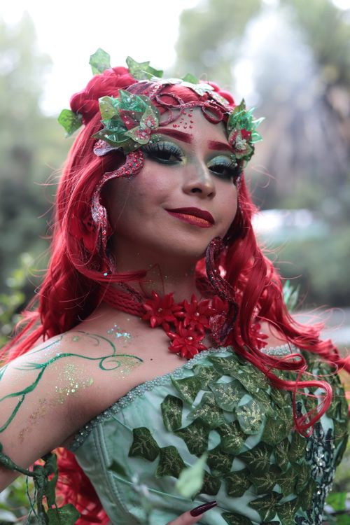 Free Portrait of a woman in nature-themed cosplay with red hair and intricate makeup. Stock Photo