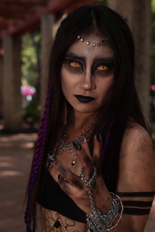 Free Intense gothic portrait of a woman in dark costume with dramatic makeup, outdoors. Stock Photo