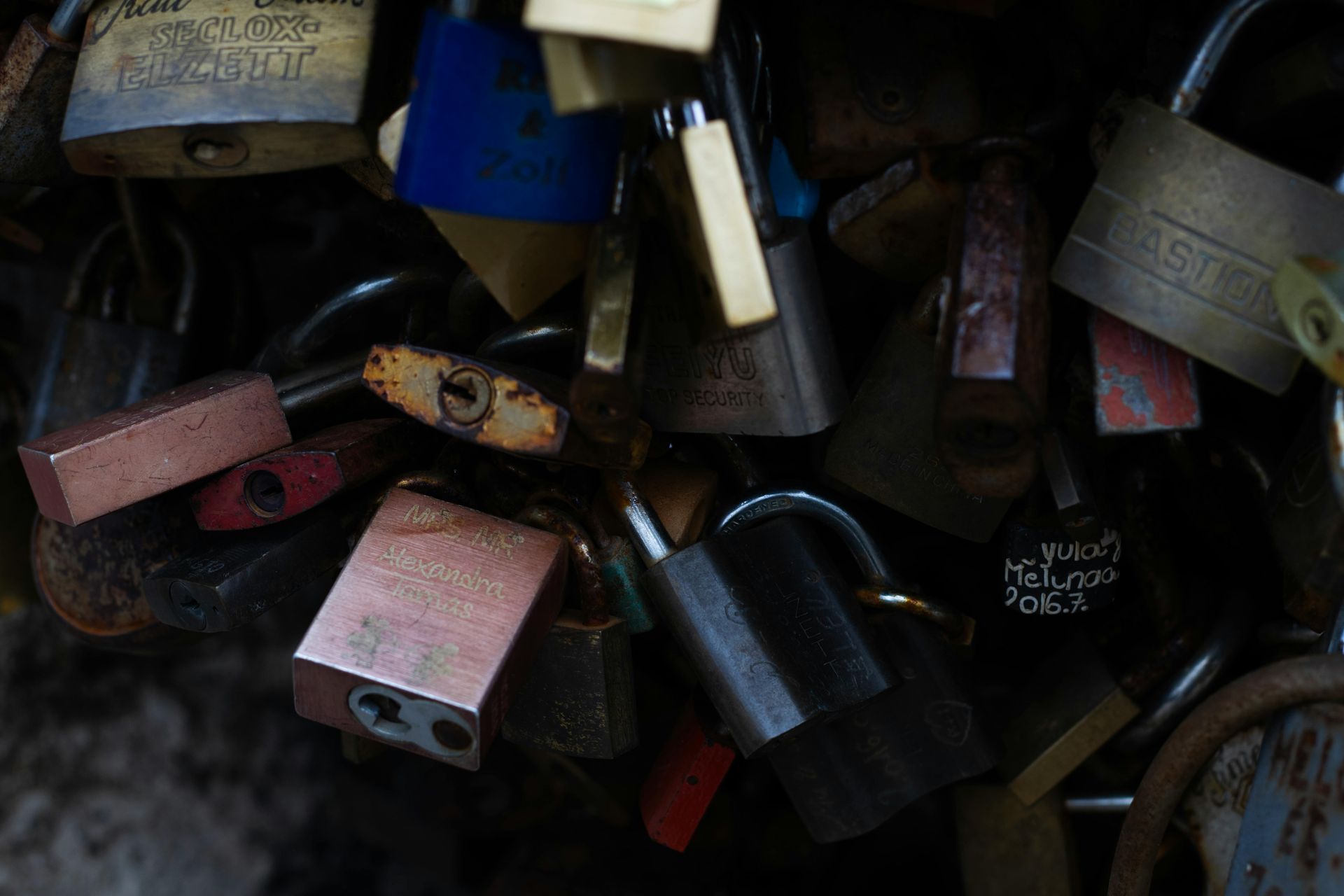 A collection of love locks attached to a bridge fence, symbolizing eternal love.