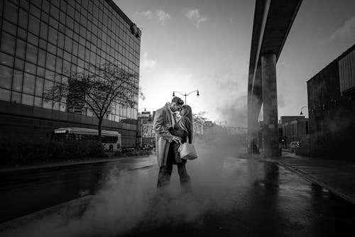 Grayscale Photography of Man and Woman Standing While Facing Each Other