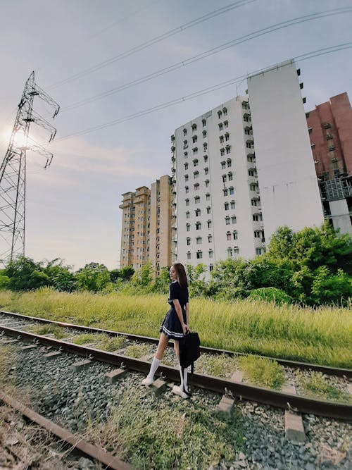 Free Woman Standing on Rail Track Stock Photo