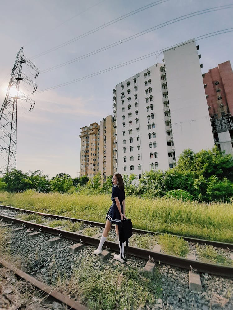 Woman Standing On Rail Track