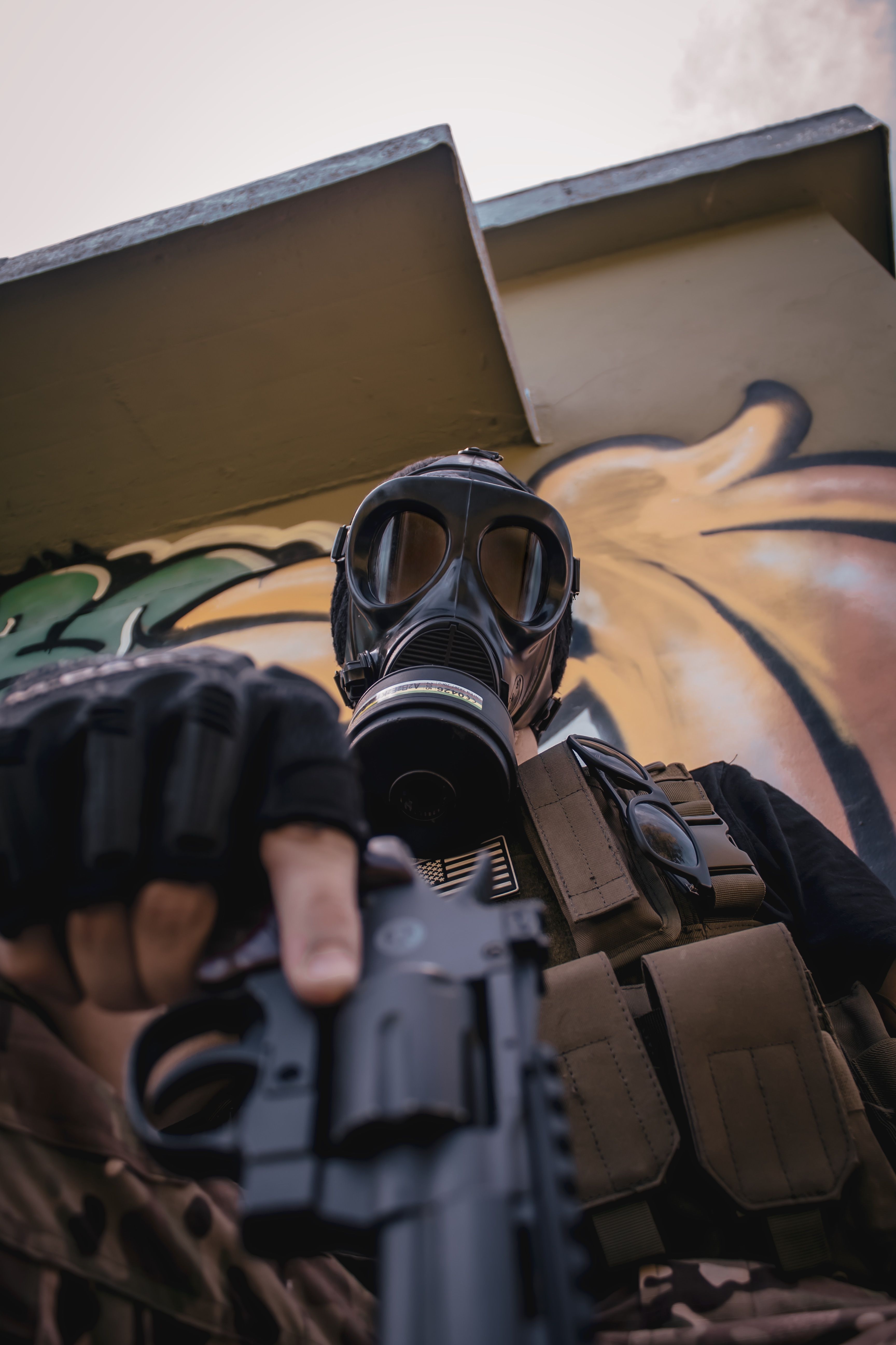 Soldier in Gas Mask Holding Weapon in Urban Setting · Free Stock Photo