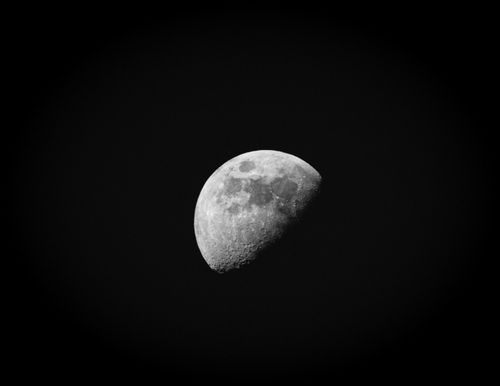 Free Black and white photo of a crescent moon against a clear night sky, showcasing lunar details. Stock Photo