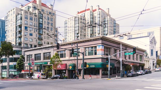 City street view featuring modern buildings and crossing at an urban intersection.