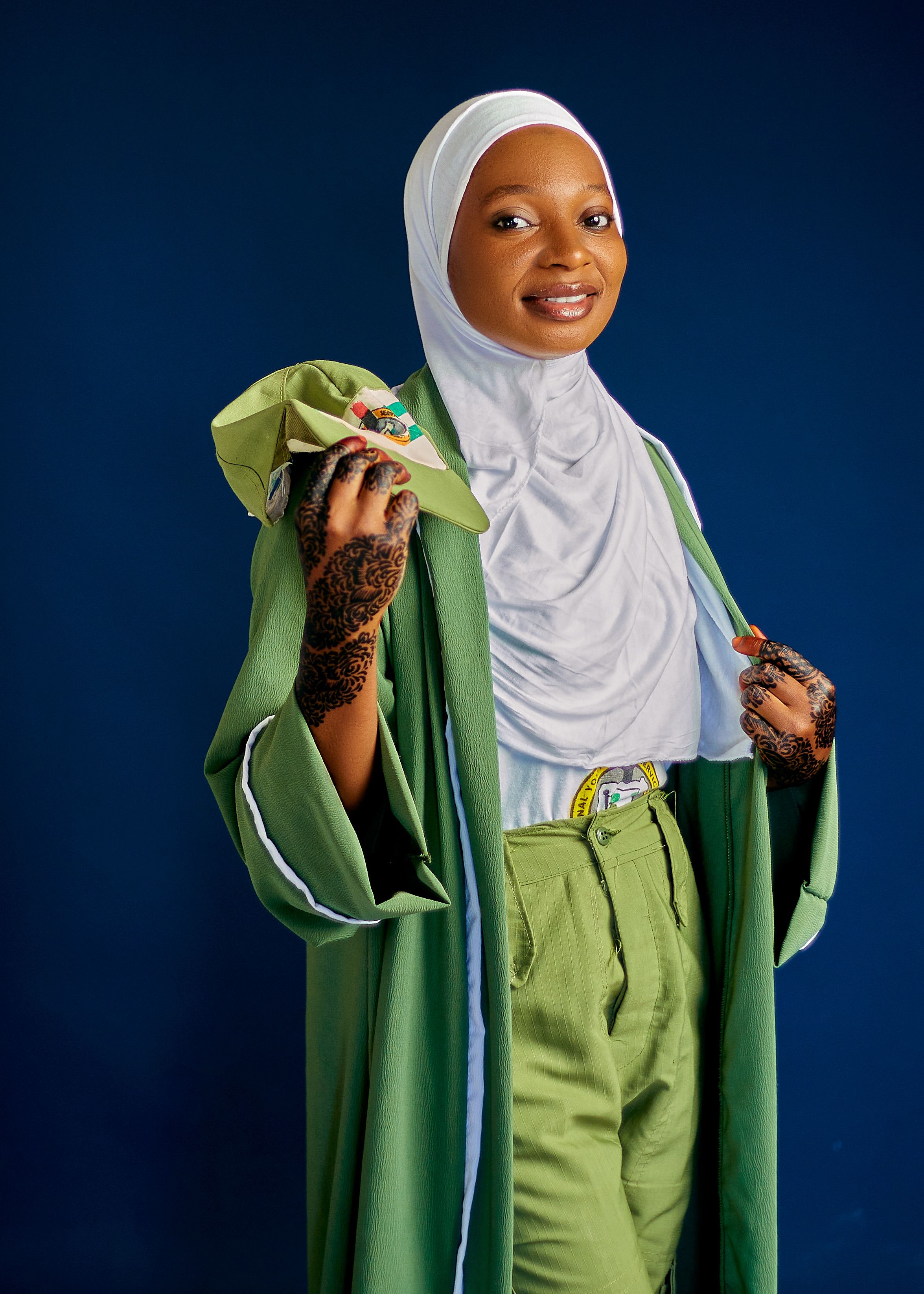 Young Woman in Graduation Attire with Henna Art · Free Stock Photo