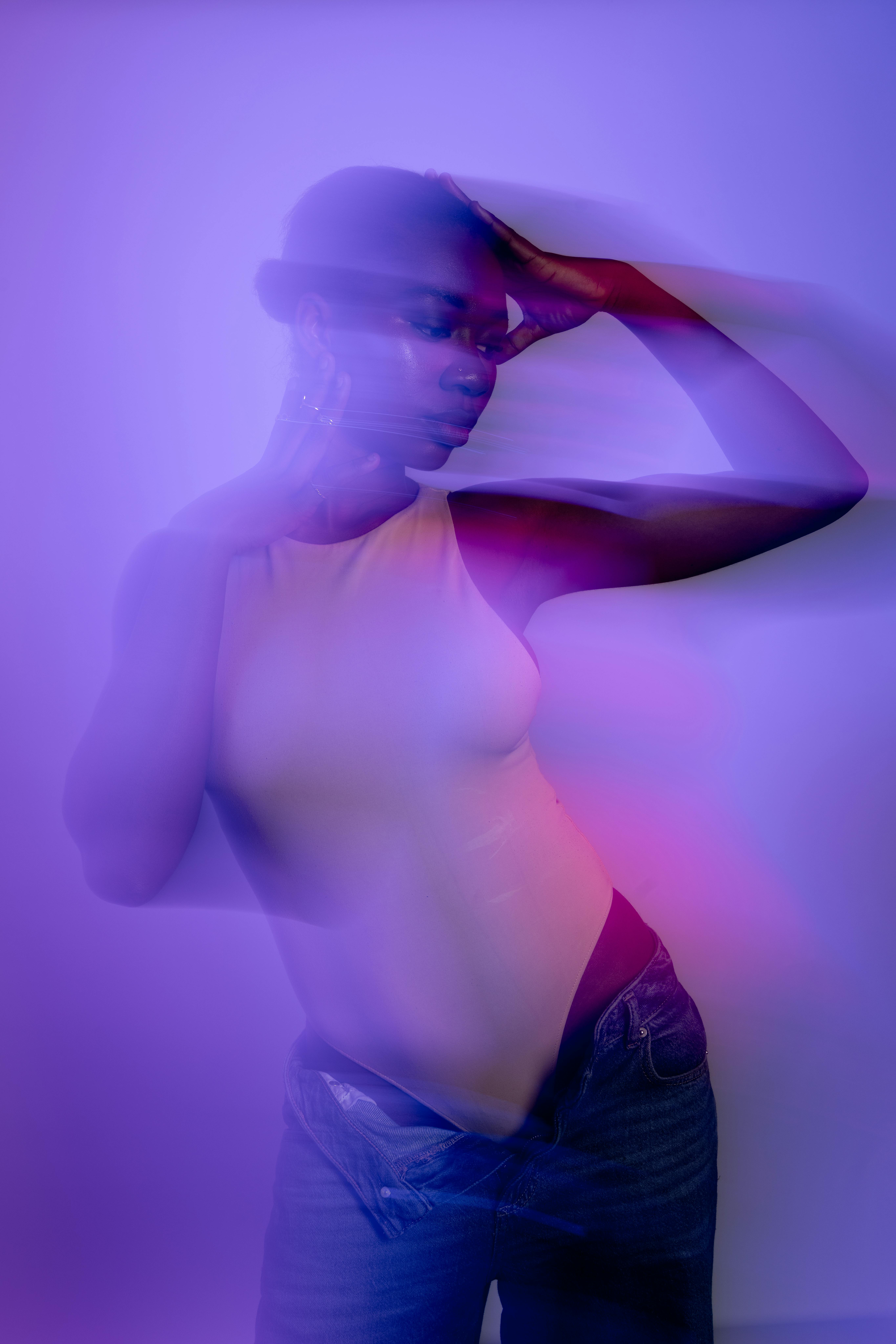 An artistic portrait of a woman in soft, colorful, ethereal light creating a dreamlike mood.