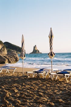 Relaxing beach scene with umbrellas and loungers at sunrise, capturing tranquility and beauty of coastal life.