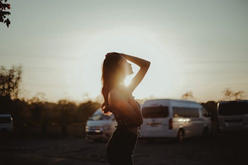 Free Selective Focus Photo of Woman Against Sun Stock Photo