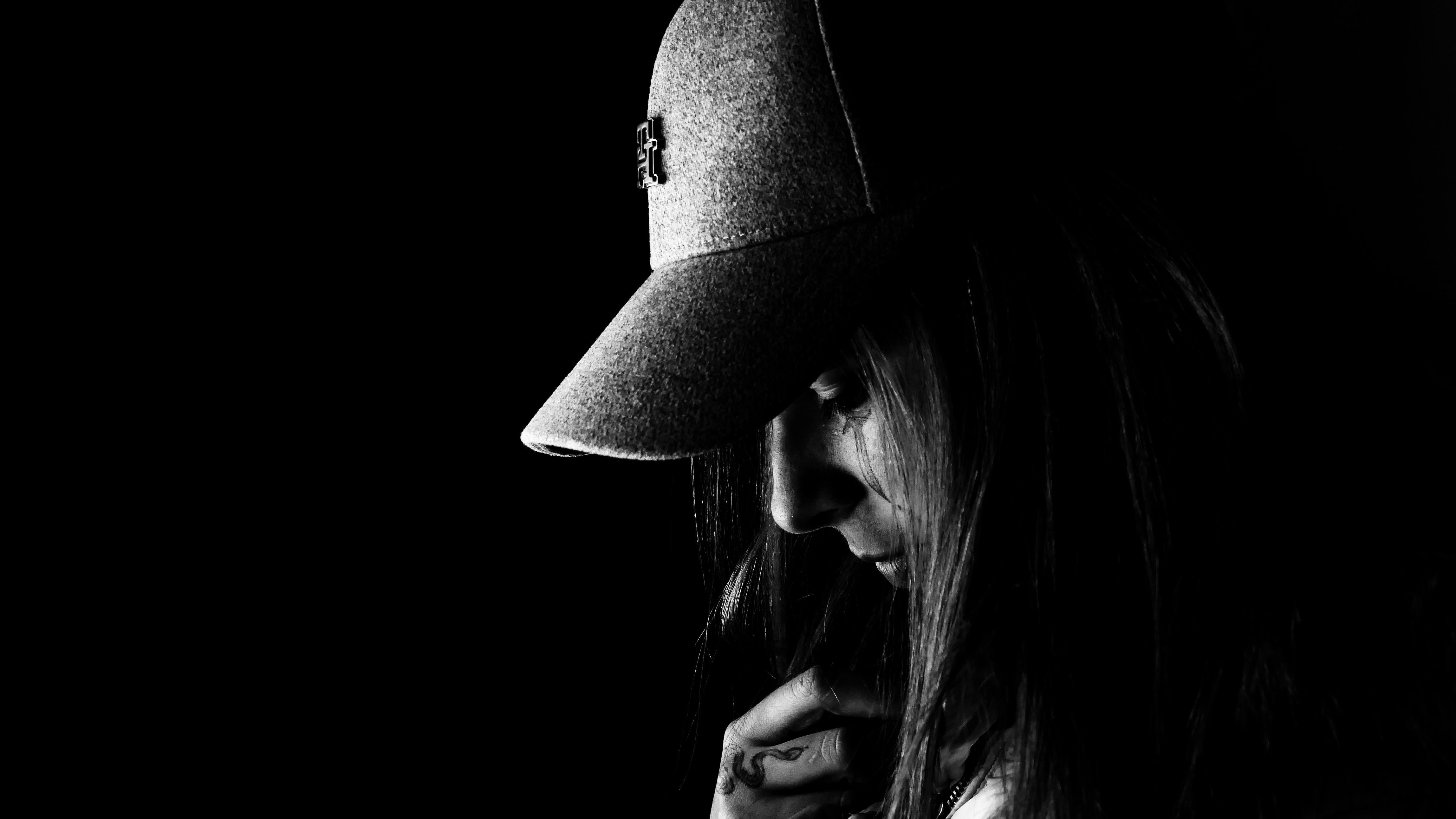 Moody Black and White Portrait of Woman in Hat · Free Stock Photo