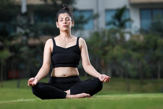 A young woman meditating in a park, practicing yoga in a serene outdoor setting.