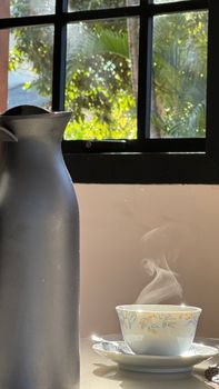 A cozy morning coffee setup near a sunlit window.