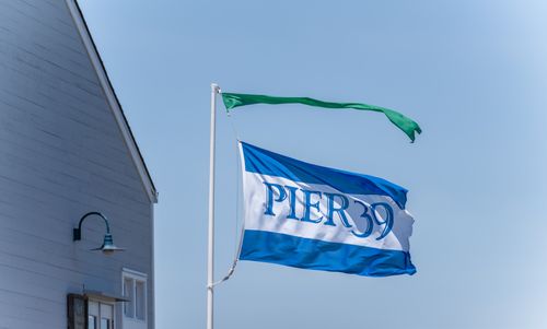 Free Captivating image of the Pier 39 flag waving under a clear San Francisco sky. Stock Photo