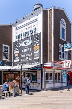 Colorful street scene at Fisherman's Wharf, San Francisco with fish and chips shop.