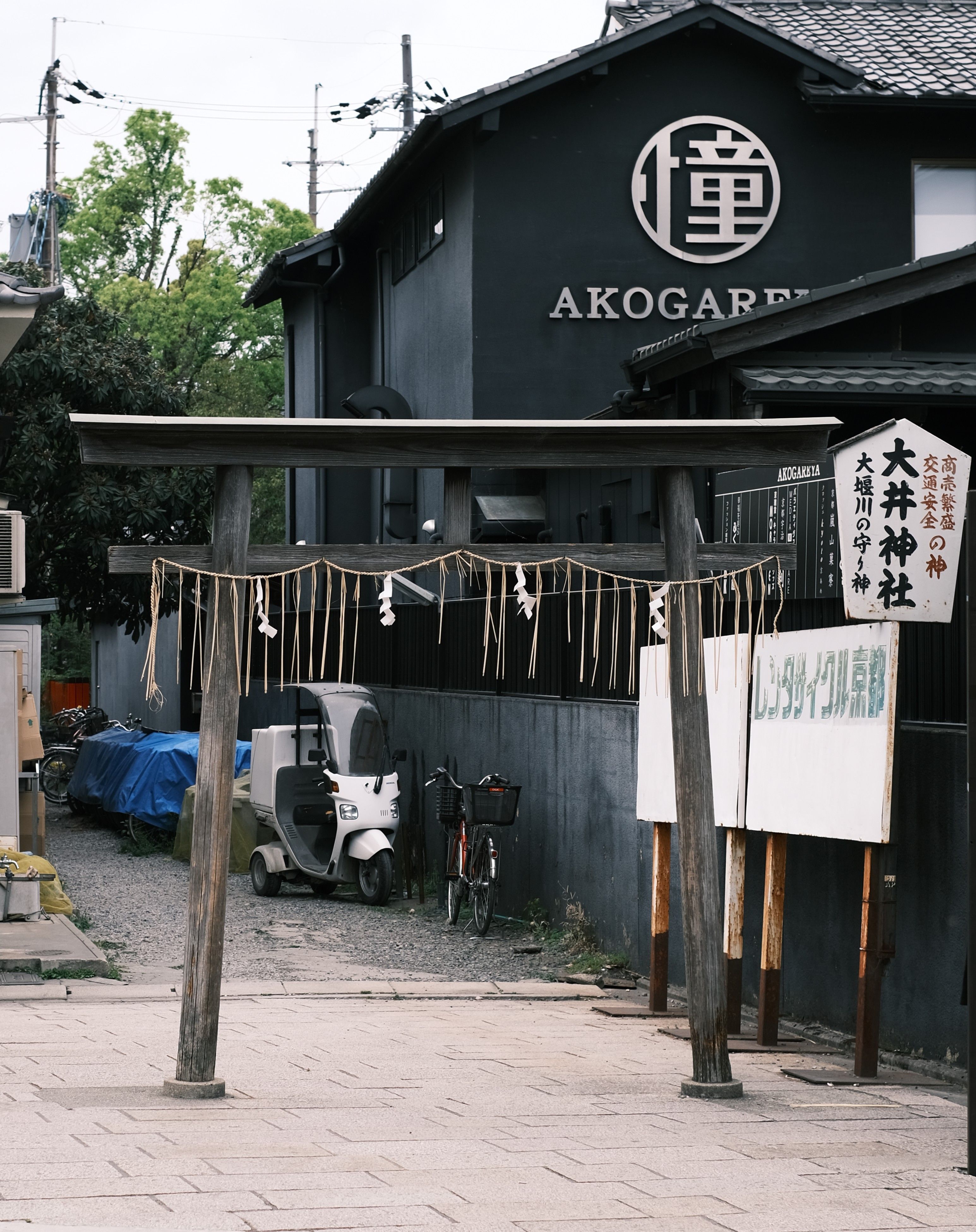 A serene torii gate in front of a Japanese building, symbolizing tranquility.