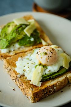 Savor the taste of creamy avocado toast topped with a perfectly poached egg and cheese.