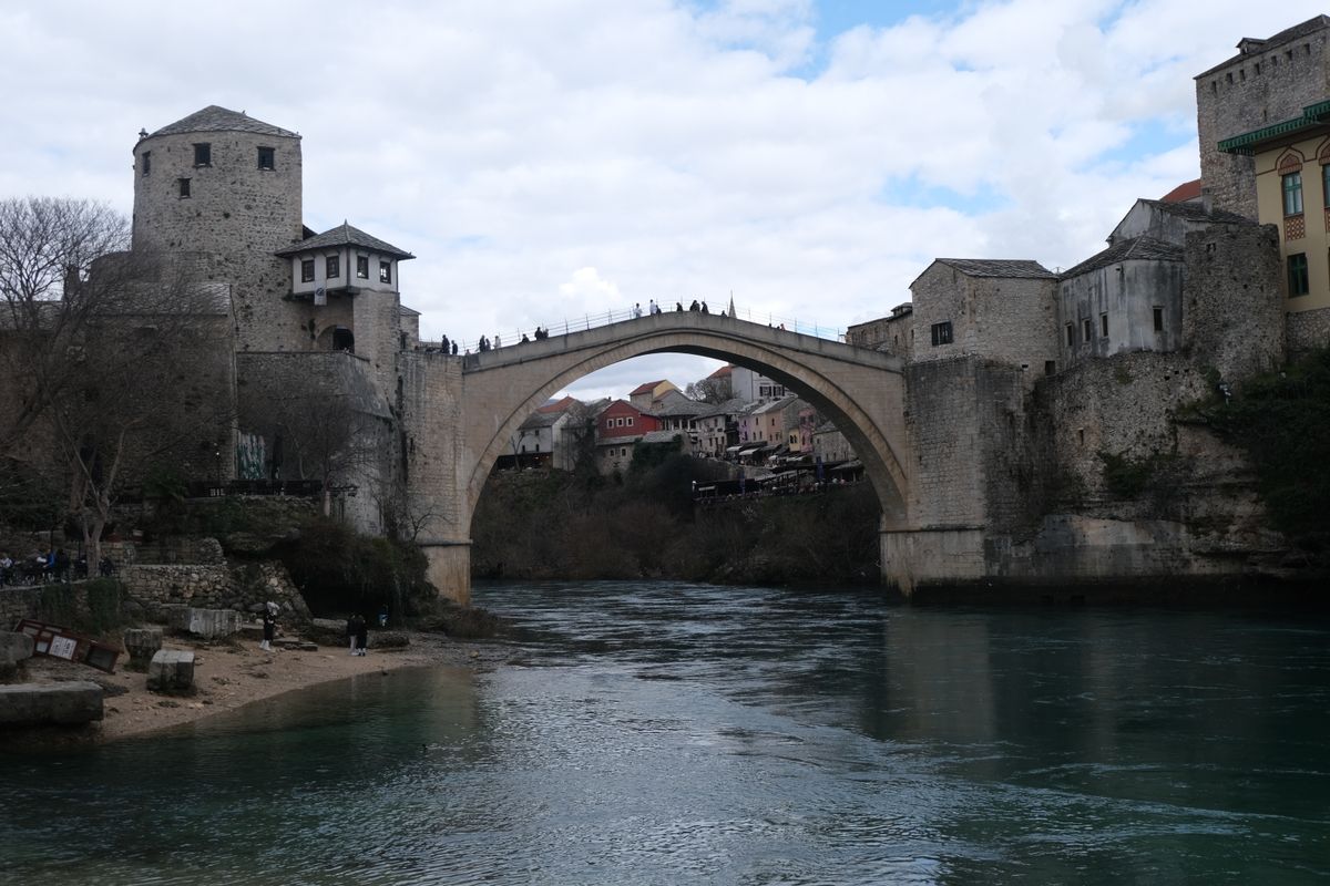 Mostar Old Bridge spanning the Neretva River with historic architecture on both banks