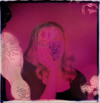 A surreal pink-toned instant photo with a person obscured by artistic distortions in a vintage style.