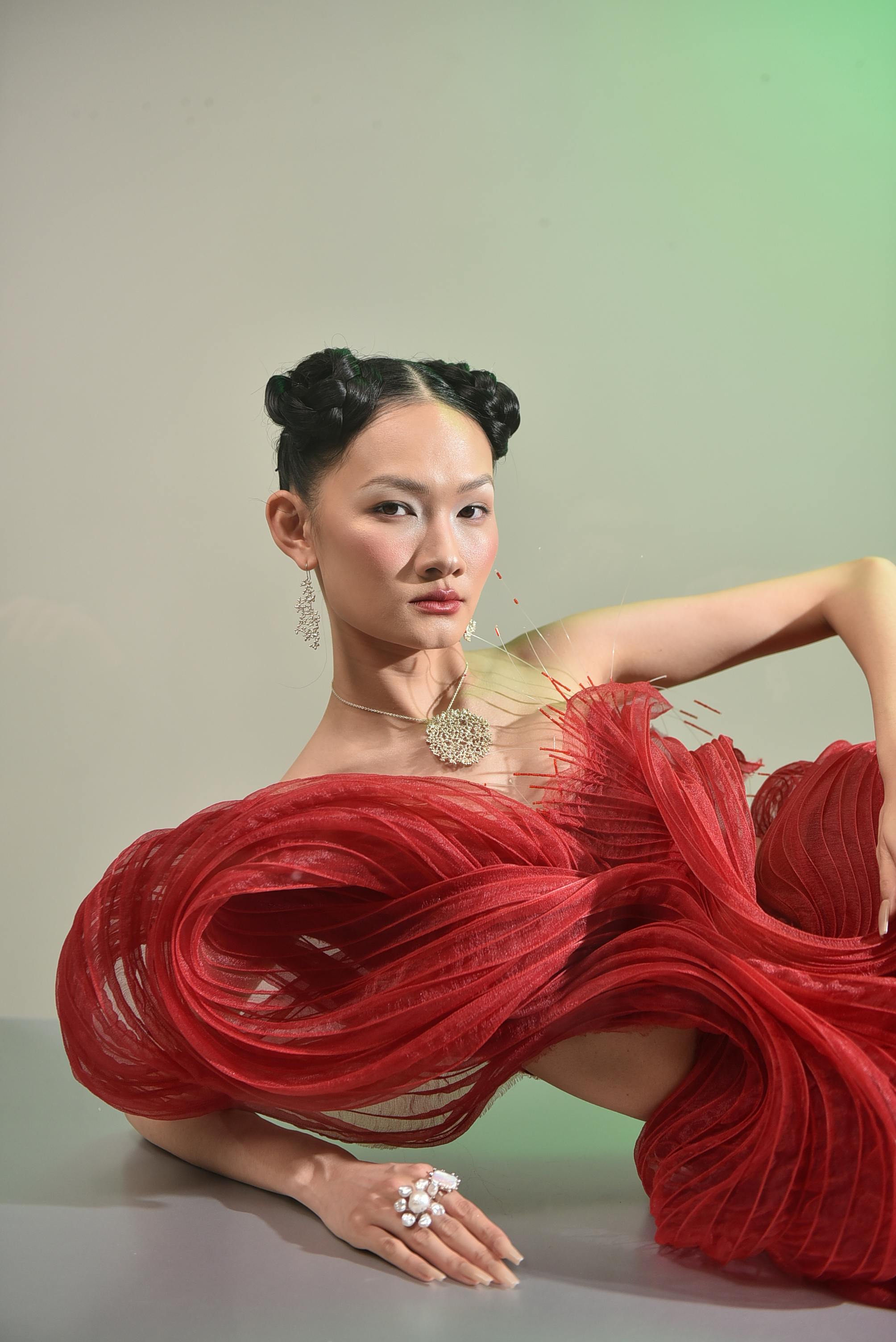 Stunning portrait of a model wearing a bold red fashion piece, exuding elegance.