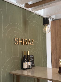 Elegant wine bar interior featuring a Shiraz sign and minimalist decor.