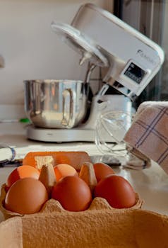 Sunlit kitchen scene with a stand mixer and fresh eggs, perfect for baking inspiration.
