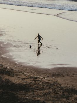 A lone soccer player on a beach in Rabat, Morocco at sunset.