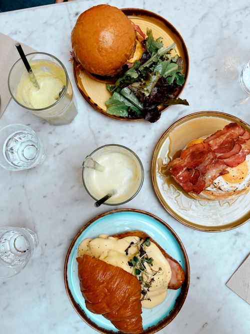 Free Overhead view of appetizing brunch items with refreshing drinks on a marble table. Stock Photo