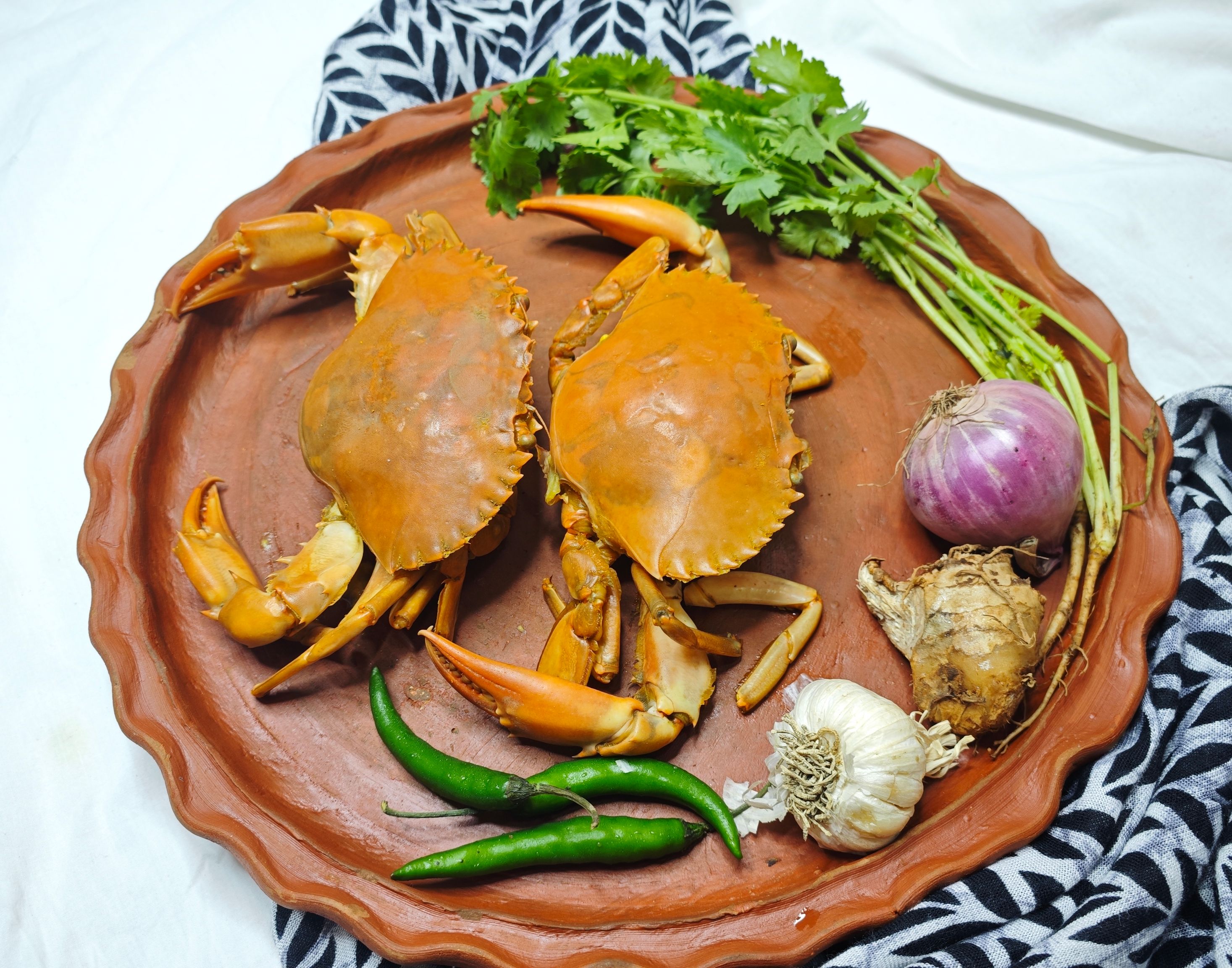 Whole mud crab wok-tossed with ginger and shallot, a live seafood specialty at The River Orchid