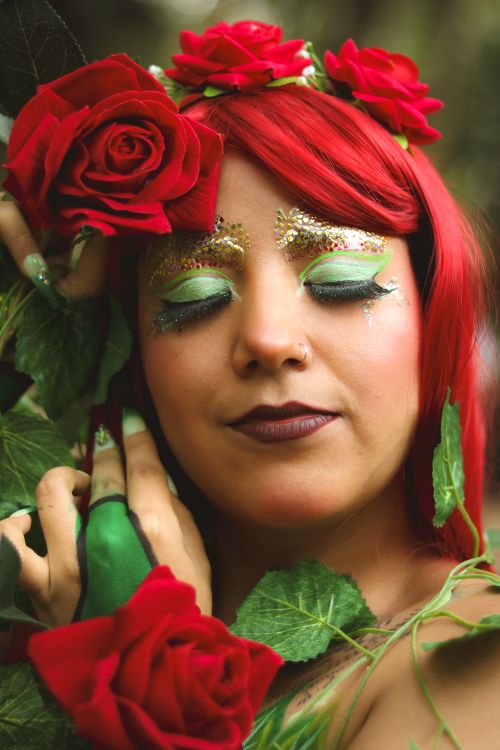 Free A woman adorned with roses poses gracefully in an enchanting setting. Stock Photo