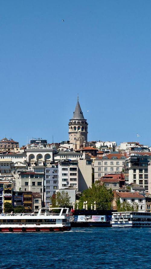 Free Scenic view of Galata Tower with boats on the Bosphorus in Istanbul. Stock Photo