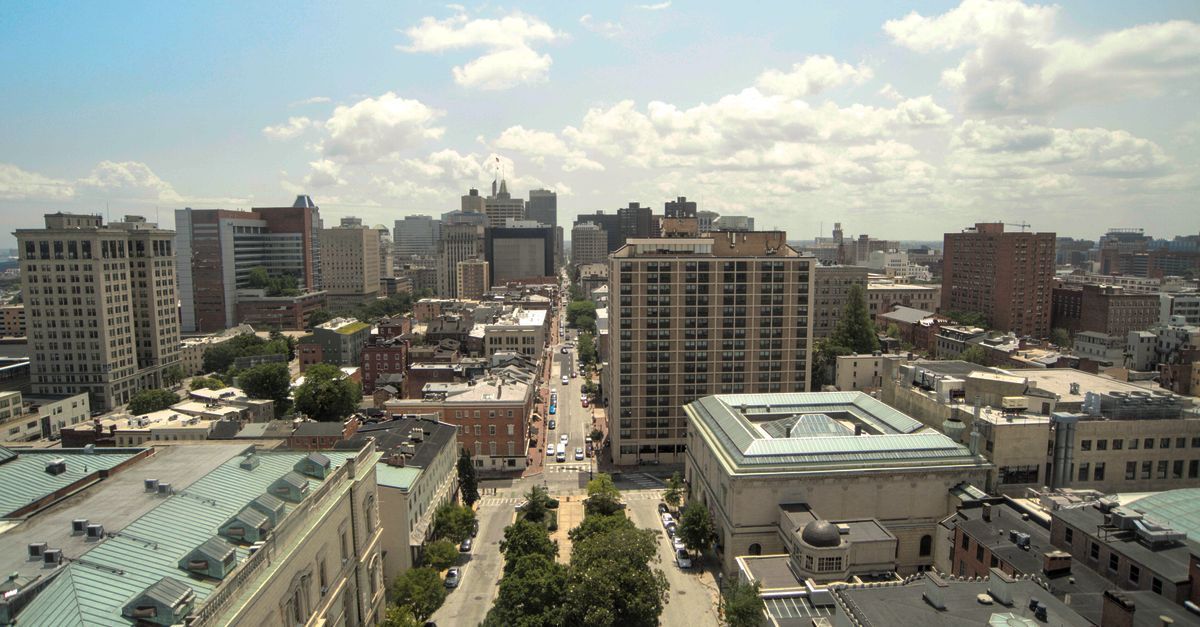 Aerial view of downtown Baltimore cityscape with historic architecture and skyline under clear skies.