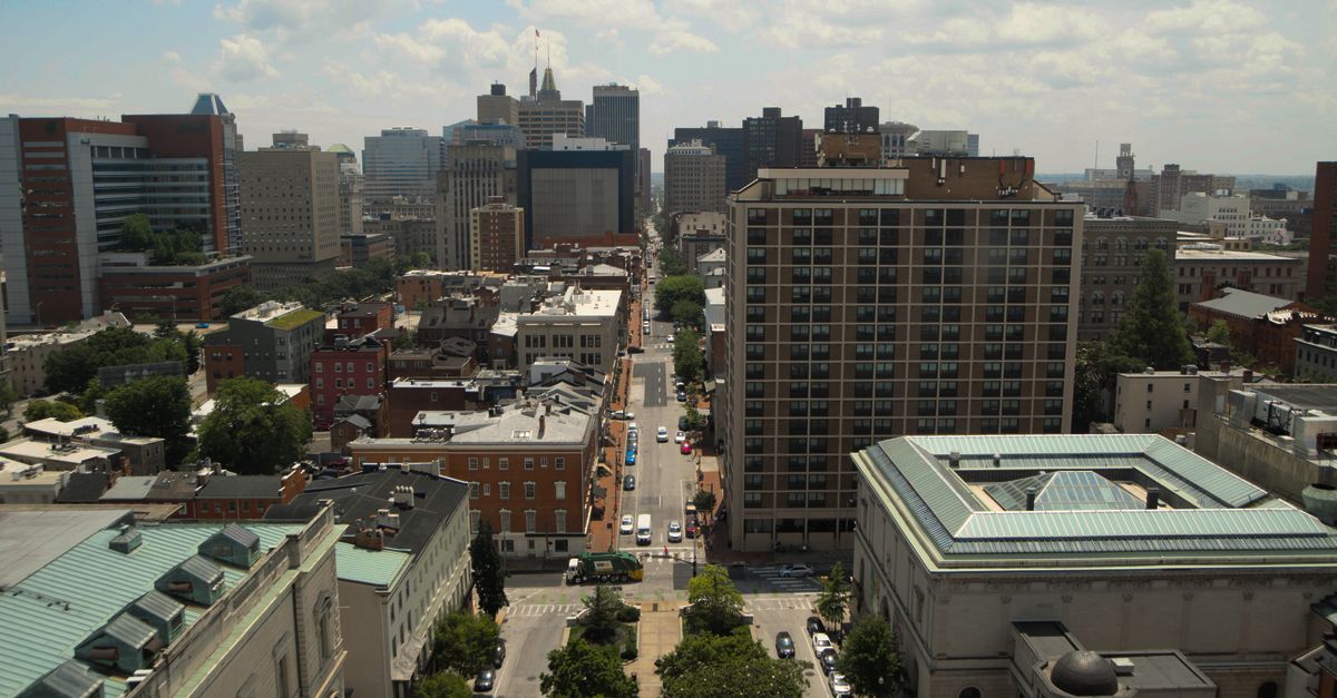 Panoramic aerial view of downtown Baltimore's skyline featuring skyscrapers and residential buildings.