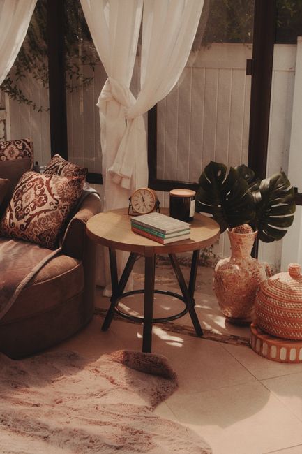 Warm and inviting living room corner with natural light, featuring elegant decor and comfortable seating.