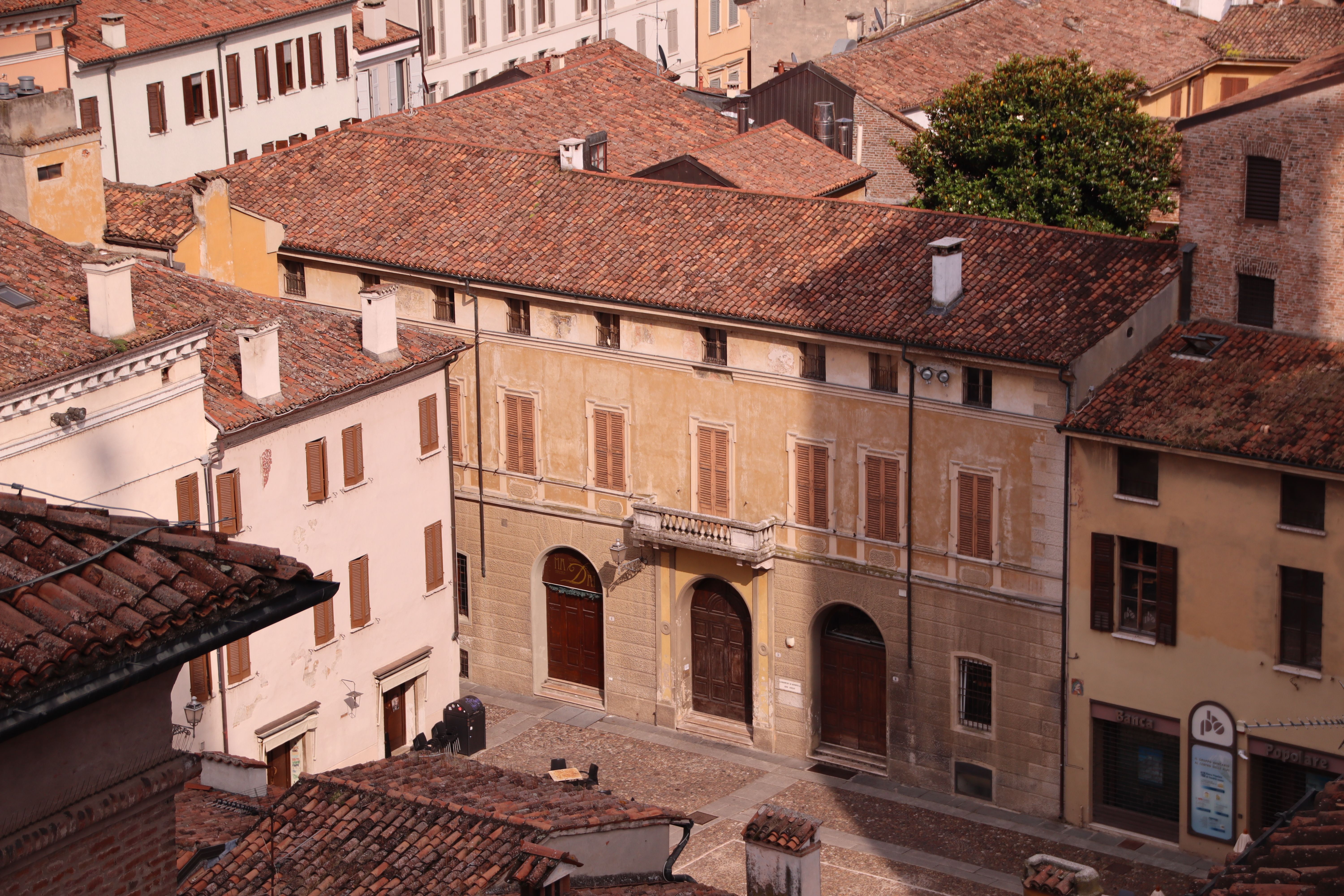 Aerial view of historical buildings in Mantova, Italy showcasing classic architecture under soft daylight.