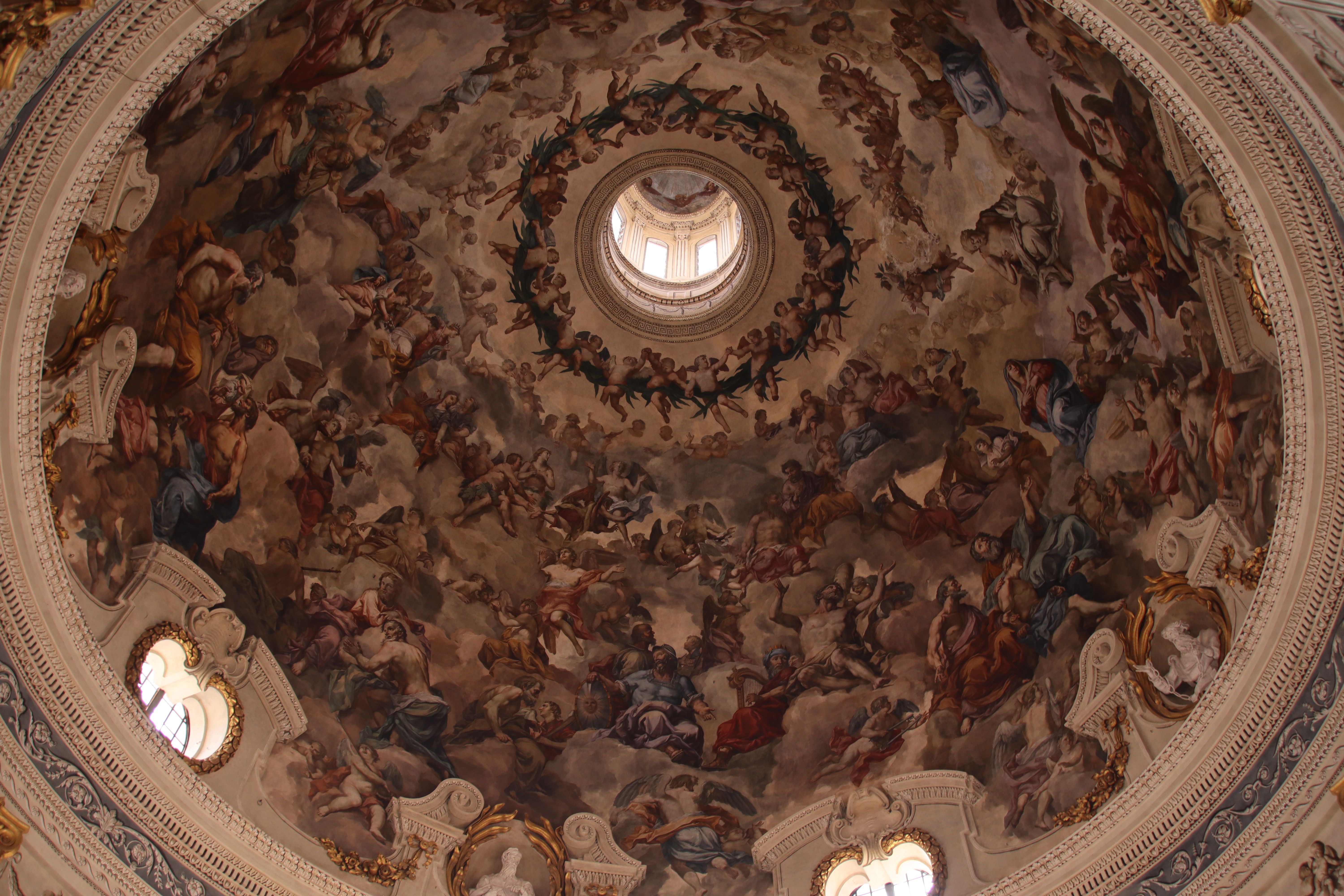 Ornate interior of St. John's Co-Cathedral in Valletta, Malta, with gilded walls and ceiling.