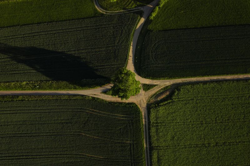 A stunning aerial view of lush green fields intersected by country roads in Germany.