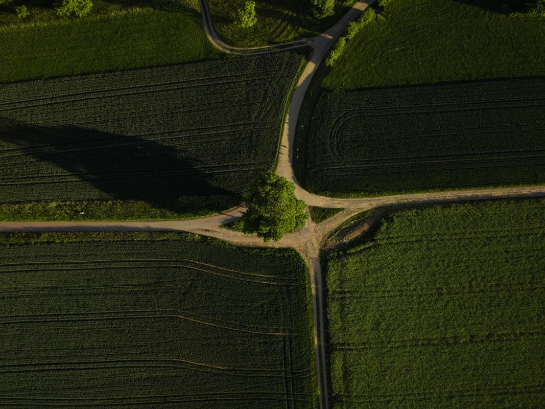 A crossroads cutting through open fields - Religion vs Christianity