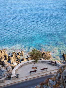 Beautiful coastal view in Greece overlooking azure waters and rocky shore. Ideal travel destination imagery.