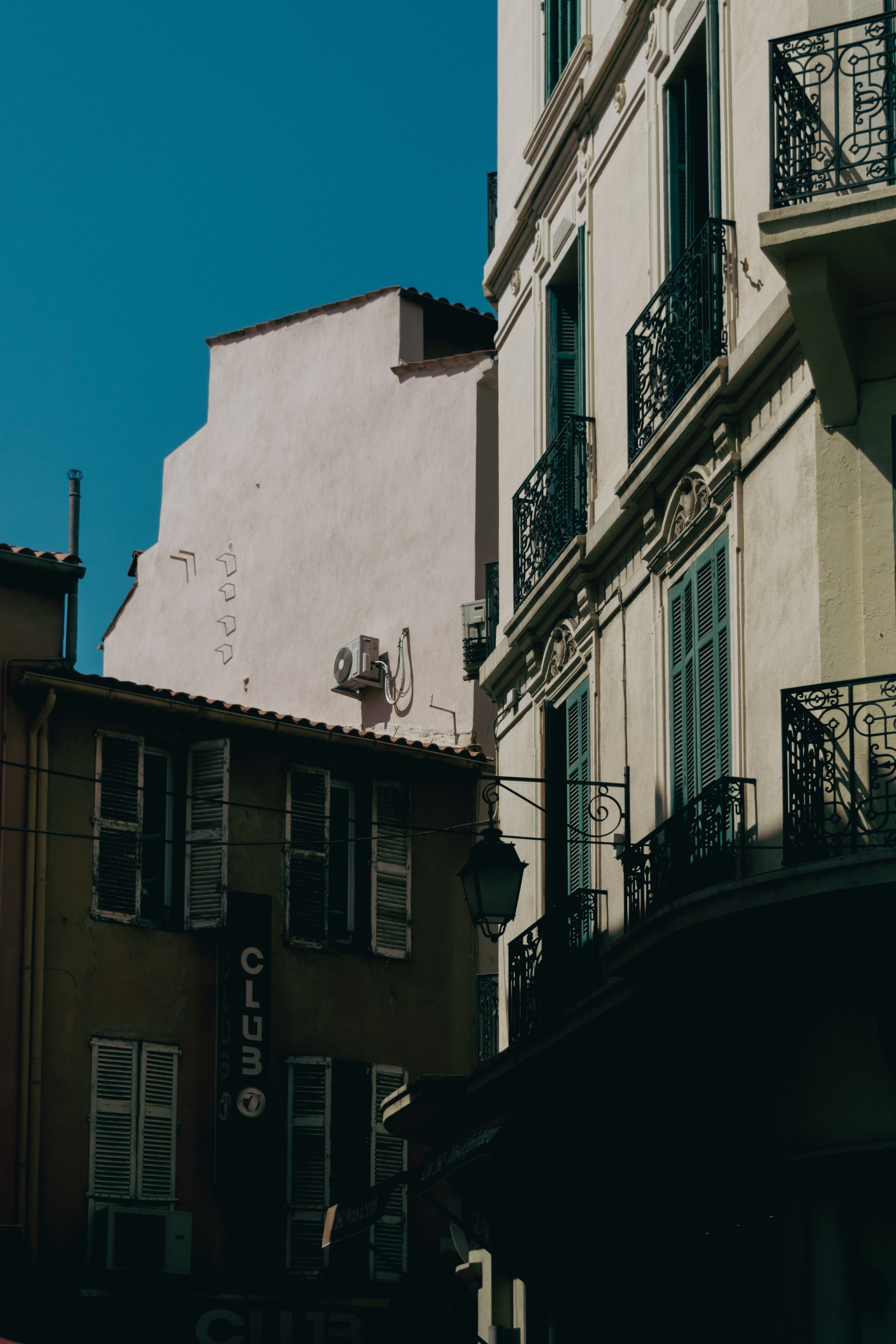 Charming street view of classical architecture in Cannes under a bright sky.