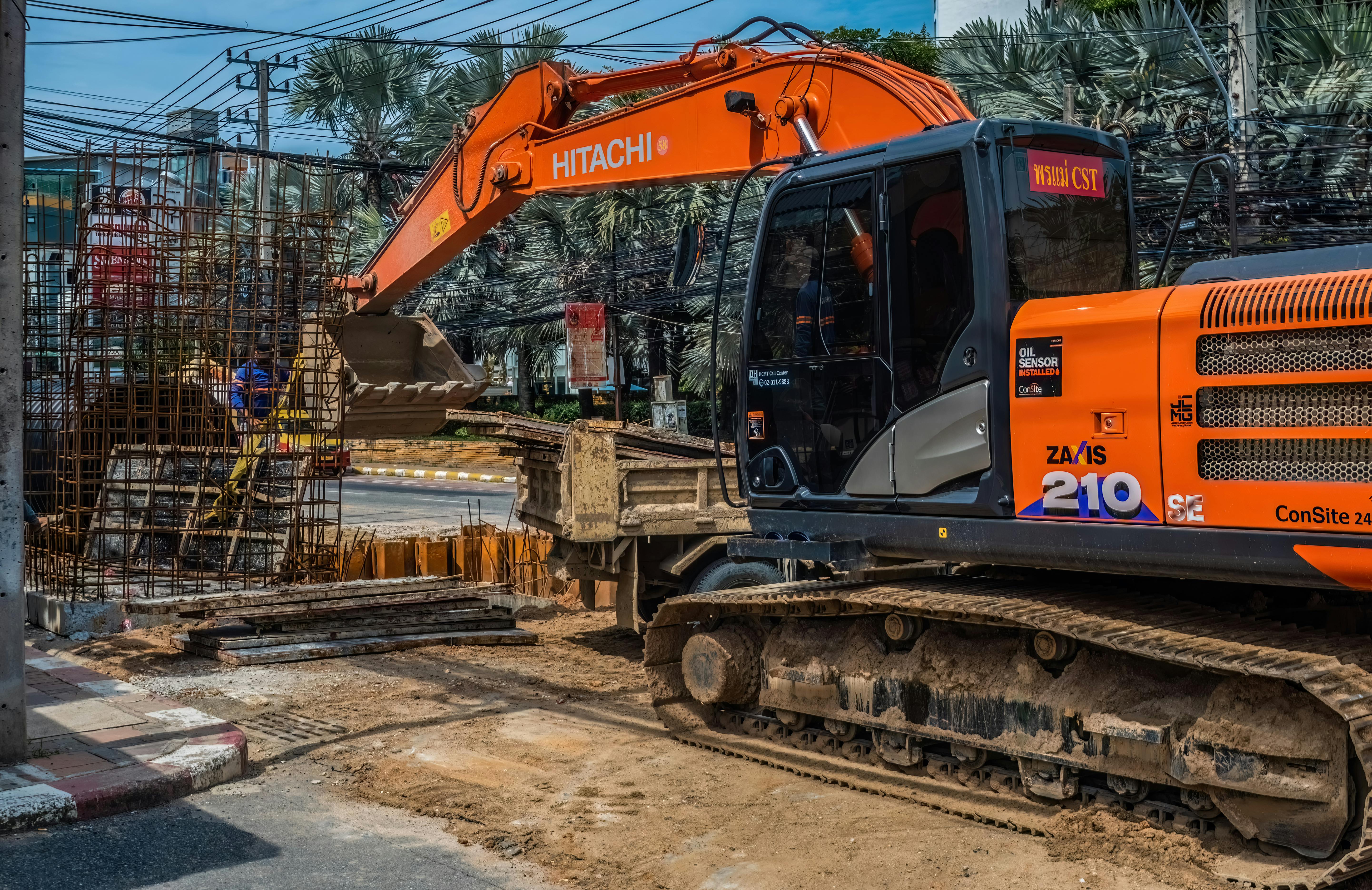 Construction site with heavy machinery and workers in Pattaya, Thailand.