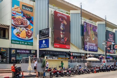 Free Street view of a shopping mall facade with prominent signage in Pattaya, Thailand. Stock Photo